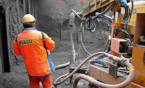 Production of a steel fibre shotcrete test specimen (the formwork units can be seen in the background) Production of a steel fibre shotcrete test specimen (the formwork units can be seen in the background)