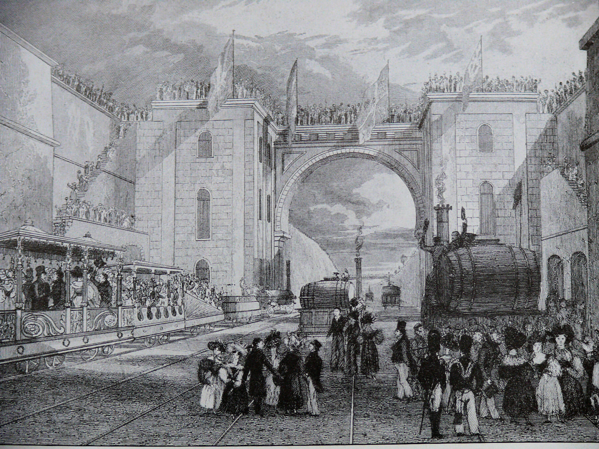 Media File No. 140163 Liverpool & Manchester Railway - engraving by I. Shaw showing the inauguration of the railroad line. The official convoy is stopped in fron of the Moorish Arch in Liverpool Station