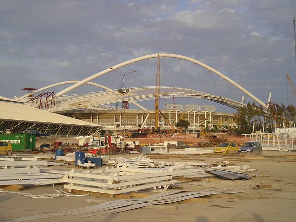 OAKA Olympic Stadium (2004) The roof hangs in a giant arc of 80 m high. Each arc consists of two 3,5 m diameter tubes with a span of 304 m and support the new state-of-the-art roof. Movement of arc and roof construction weighing 8500 ton is done simultaneously using Enerpac PLC-controlled hydraulic systems with four 150 ton pull cylinders with 2 m stroke. These double-acting cylinders are attached to shoes in a sliding and guiding system pulling the arc with roof assembly step-by-step into the final position