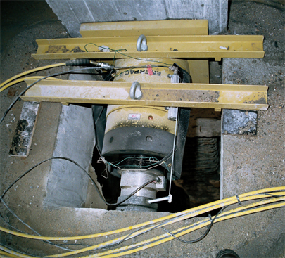 Prado Enerpac 500 ton double-acting lock nut jack with positioning sensor and Class A load cell used to keep the basement walls of the Prado extension in position