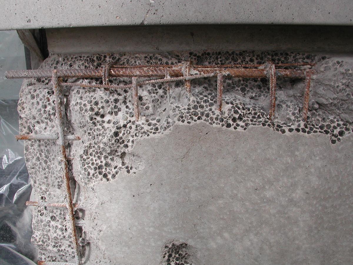 Schadstellen im Beton, teilweise mit freiliegendem Bewehrungsstahl 