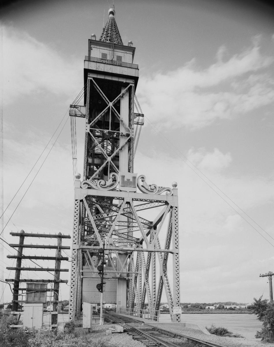 Media File No. 199220 SOUTHEAST PORTAL AND TOWER FROM RAILBED, TO NORTHWEST - Cape Cod Canal Lift Bridge, Spanning Cape Cod Canal, Buzzards Bay, Barnstable County, MA (HAER MASS,1-BUZBA,1–7)