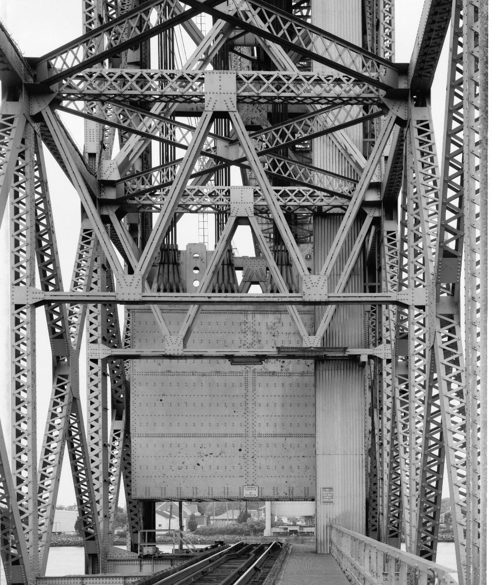 Media File No. 199223 DETAIL, SOUTHEAST SPAN THROUGH CANAL, VIEW BLOCKED BY STEEL, CLAD COUNTER WEIGHT, WATER SPAN RAISED OUT OF VIEW - Cape Cod Canal Lift Bridge, Spanning Cape Cod Canal, Buzzards Bay, Barnstable County, MA (HAER MASS,1-BUZBA,1–10)