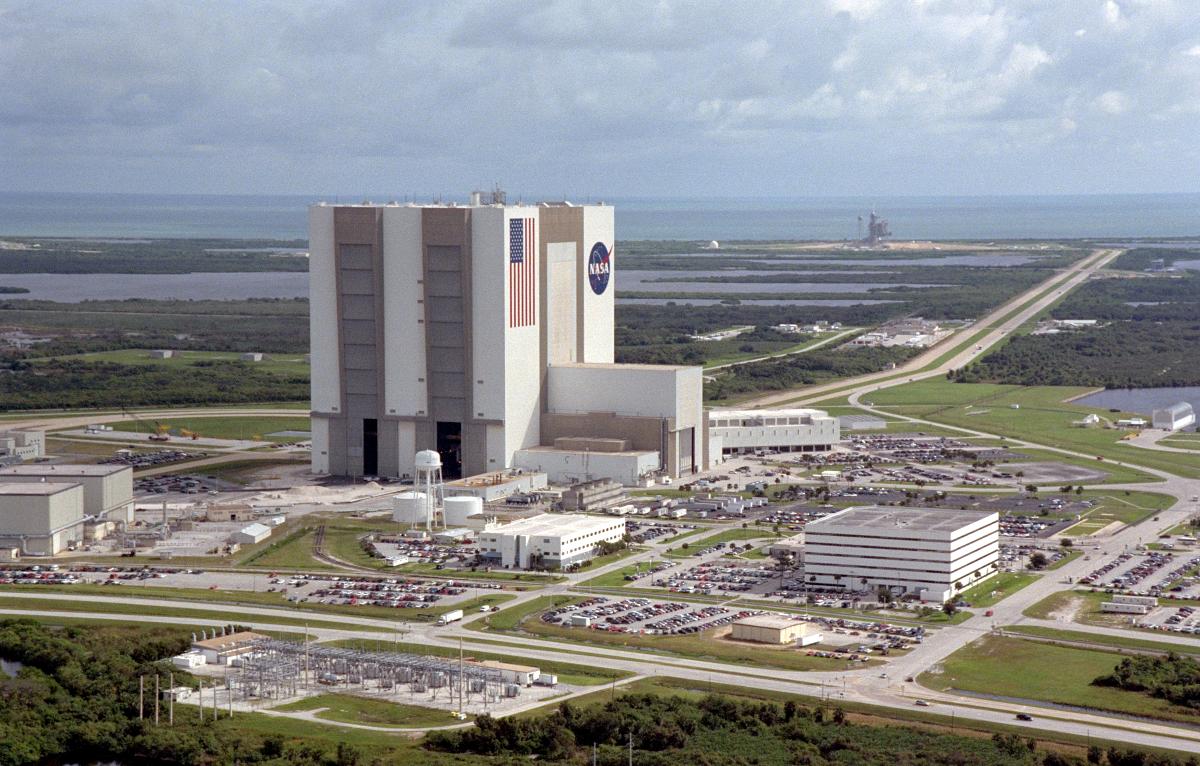 Vehicle Assembly Building (VAB) An aerial view of the Launch Complex 39 area shows the Vehicle Assembly Building (center), with the Launch Control Center on its right. On the west side (lower end) are (left to right) the Orbiter Processing Facility, Process Control Center and Operations Support Building. Looking east (upper end) are Launch Pads 39A (right) and 39B (just above the VAB). The crawlerway stretches between the VAB and the launch pads toward the Atlantic Ocean, seen beyond them. At right is the turning basin where new external tanks are brought via ship.