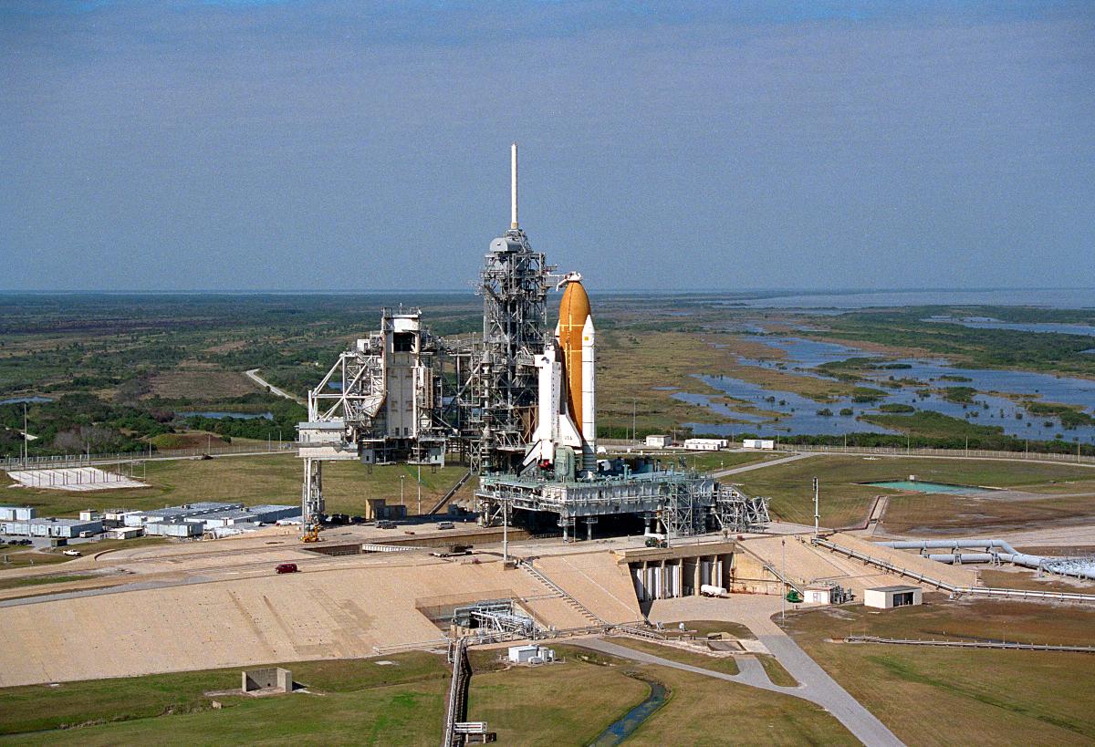 Vehicle Assembly Building (VAB) Aerial view showing Space Shuttle Columbia at Launch Pad 39B following rollout from the Vehicle Assembly Building; Columbia is being prepared for Mission STS- 75.