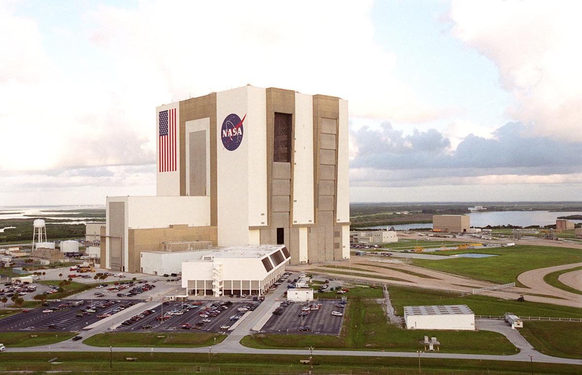 Vehicle Assembly Building (VAB) Even in this aerial view at KSC, the Vehicle Assembly Building is imposing. In front of it is the Launch Control Center. In the background is the Rotation/Processing Facility, next to the Banana Creek. In the foreground is the Saturn Causeway that leads to Launch Pads 39A and 39B.