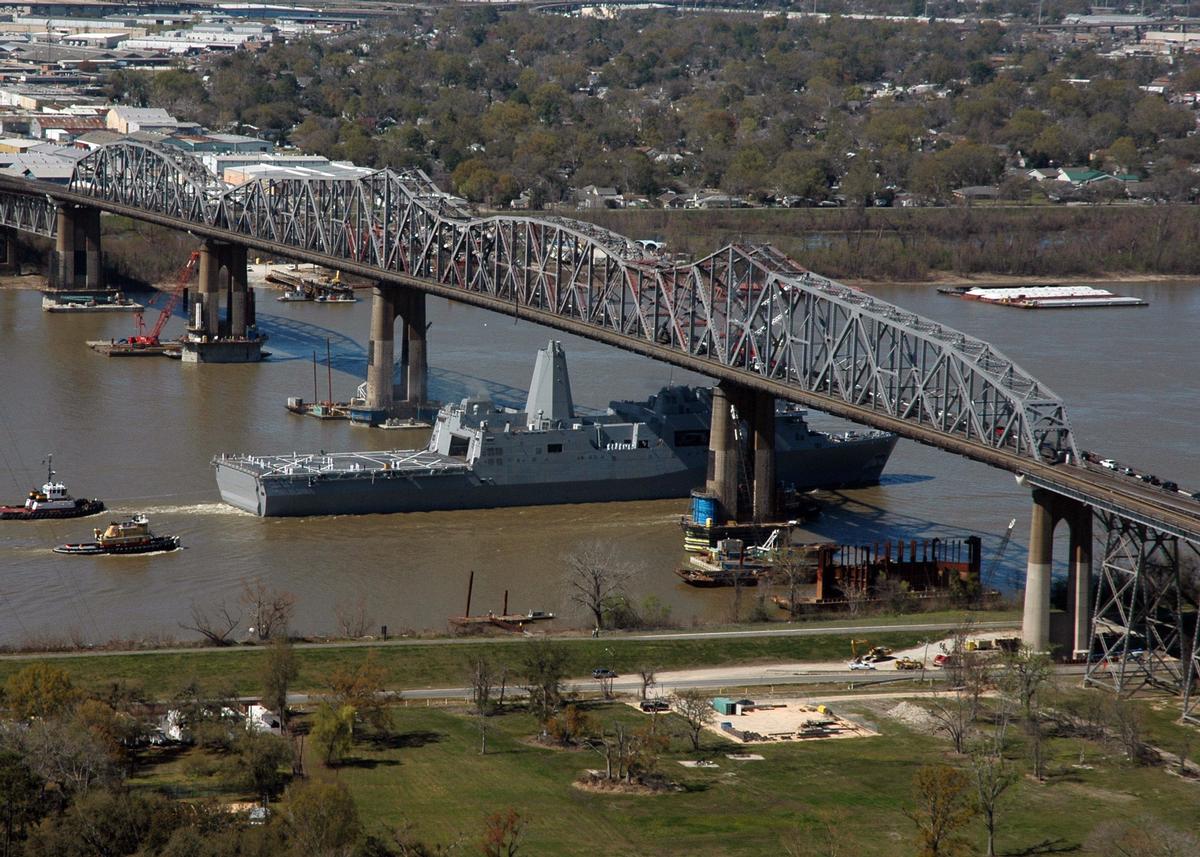 Media File No. 80255 The Pre-Commissioning Unit New Orleans (LPD 18) transits under the Huey P. Long Bridge on the Mississippi River towards New Orleans, La., March 5, 2007, for a March 10 commissioning ceremony. The San Antonio-class amphibious transport dock will functiona lly replace more than 41 classes of amphibious ships, providing the Navy and Marine Corps with modern, sea-based platforms. (U.S. Navy photo by Mass Communication Specialist 1st Class Shawn Graham)
