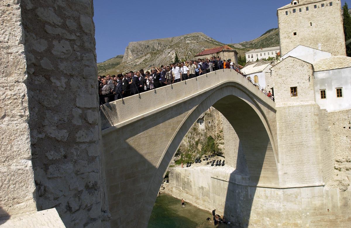 Old Mostar Bridge after reconstruction Local citizens walk over the Old Bridge (Stari Most) for the first time during the grand opening ceremony celebrating the re-opening of this bridge in Mostar, Herzegovina-Neretva Canton, Bosnia-Herzegovina (BIH). This bridge is the symbol of Mostar and was destroyed during the 1993 Balkan War