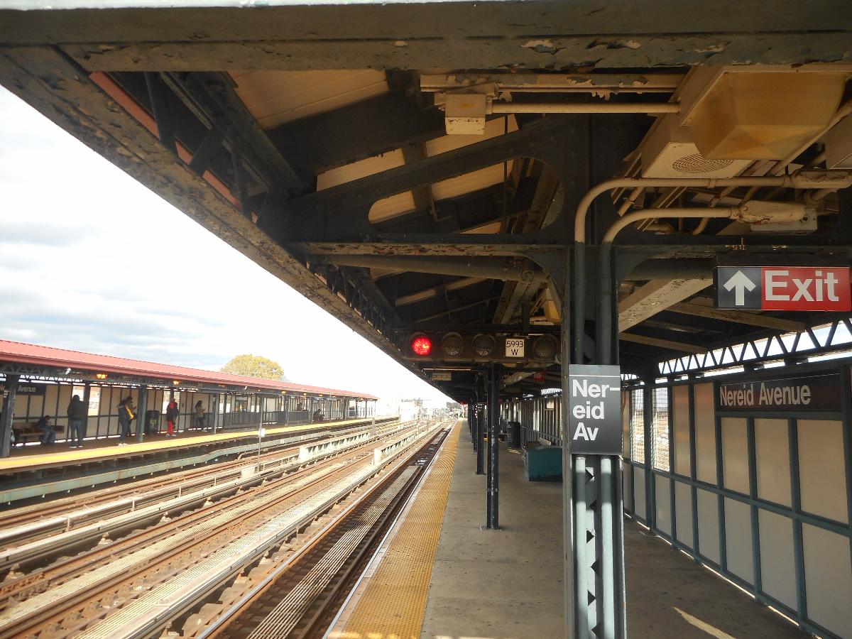 Subway signal number 5993 W along the 241st Street-bound platform of the Nereid Avenue Elevated Railway Station on the IRT White Plains Road Line Located in the Wakefield section of The Bronx, New York City. Note also the MTA Helvetica pillar sign on one of the thin steel pillars holding up the canopies that the signal is mounted under.