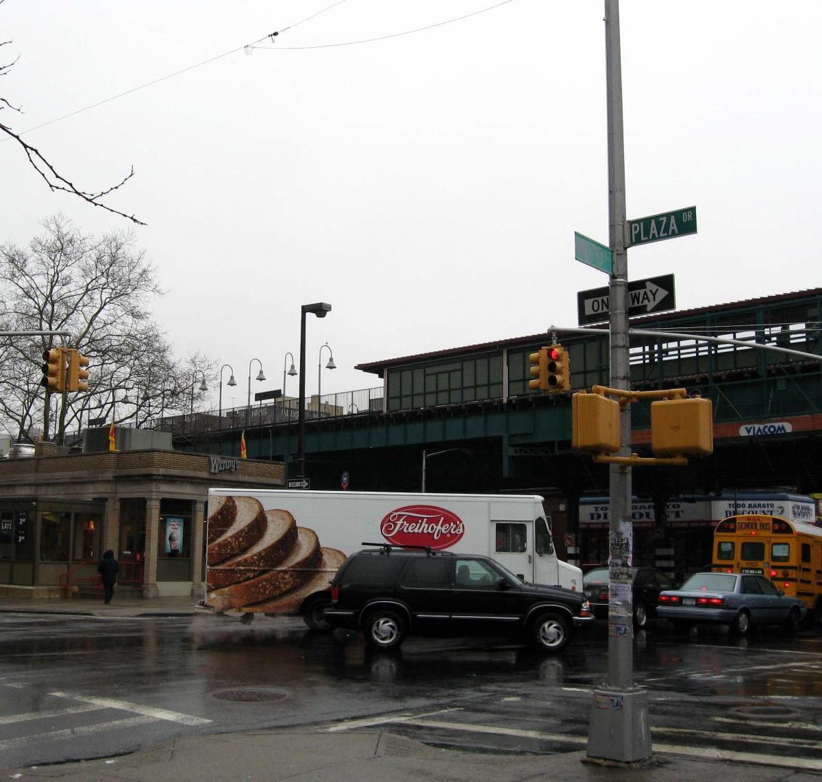 Looking east across a rainy plaza at en:170th Street (IRT Jerome Avenue Line) station in Mount Eden 