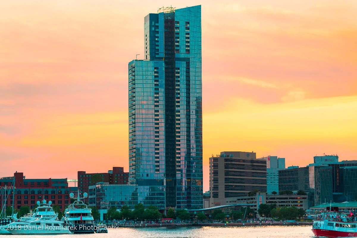 414 Light St is an apartment building in Baltimore, Maryland The building opened for occupancy in 2018. This image shows the building at sunset as viewed from the east, across the Inner Harbor. Boats from the marina, pedestrians, and the lights of Camden Yards baseball stadium are visible. As of 2018, it is on the List of tallest buildings in Baltimore.