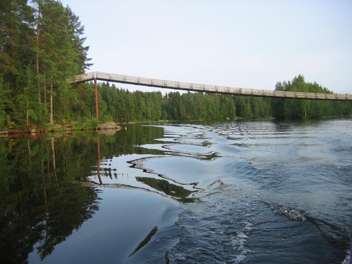 A suspension bridge over the Oulujoki river in Utajärvi, Finland, where Ahmaskoski white water rapids used to be located 