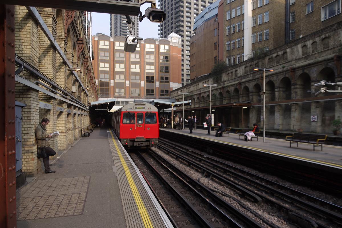 A westbound London Underground service departs Barbican 