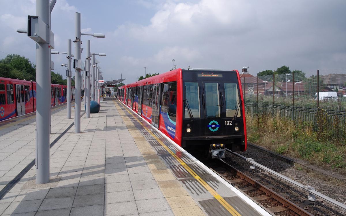A B07 train headed by 121 stands at Beckton DLR station 