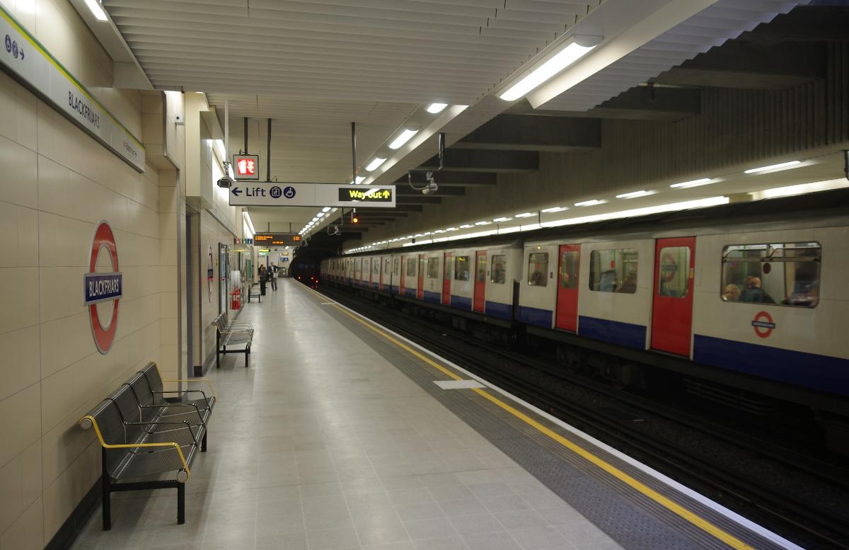A London Underground D Stock train departs Blackfriars with an eastbound District Line service 