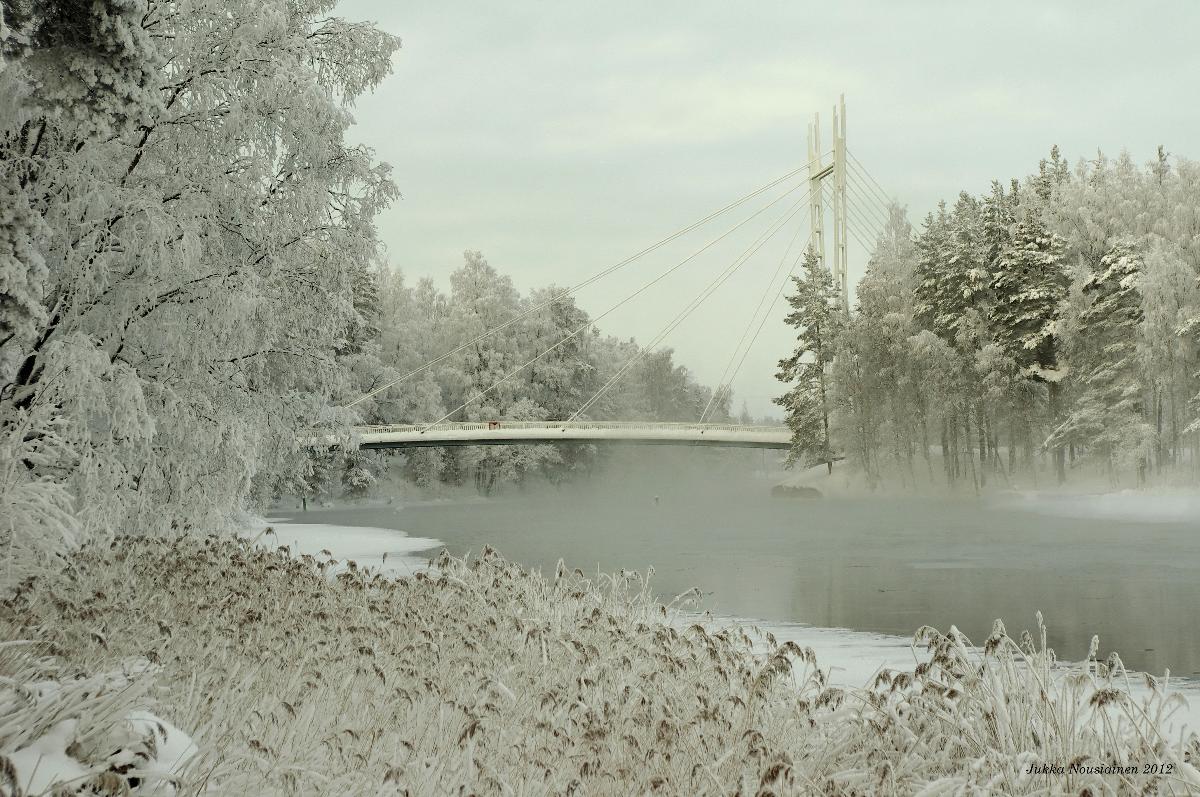 Pedestrian and bicycle bridge over the river near the center of Äänekoski at a temperature of -24 °C 