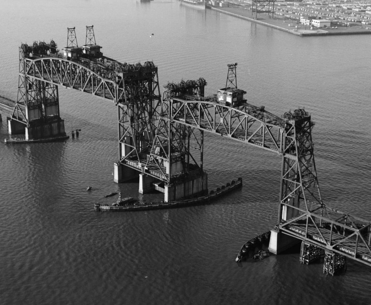 Jersey Central Railroad (CRRNJ) Newark Bay Bridge Between Bayonne and Elizabeth, New Jersey, with lifts raised. Aerial view looking northwest at 45 degree angle. The bridge was built 1924-25; dismantled in 1980.