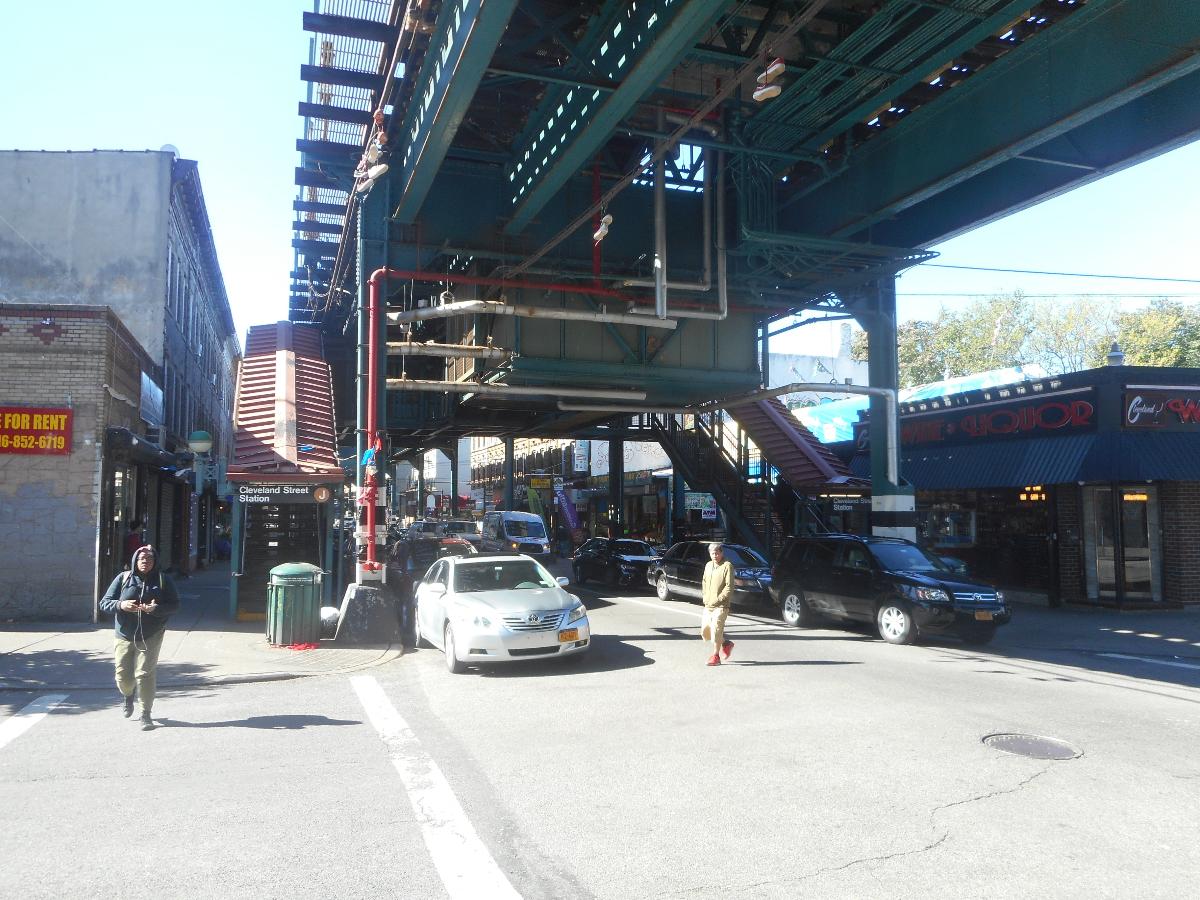 Two staircases on both the northwest and southwest corners of Fulton Street and Cleveland Street below the Cleveland Street elevated railway station On the BMT Jamaica Line in the Cypress Hills section of Brooklyn, New York City. Both staircases lead to and from the station house, but a sign within the crossunder incorrectly tells commuters that both staircases lead to the southwest corner.