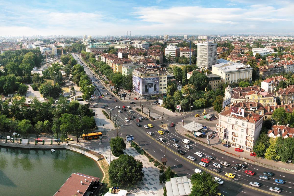 Orlov Most junction, where two of the most busy roads in Sofia intersect. Far back the golden domes of Alexander Nevski cathedral can be seen. Part of Ariana lake can be seen in the foreground, to the left
