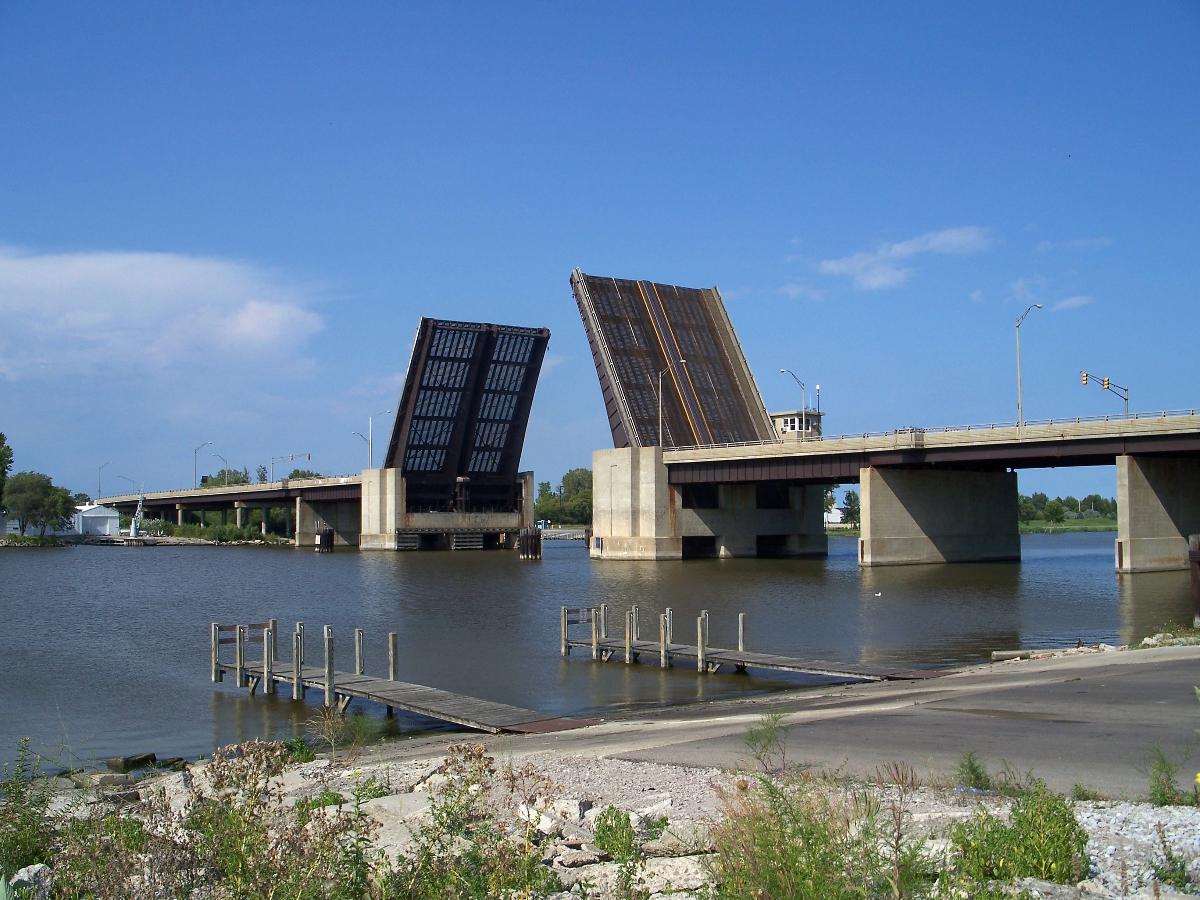 Independence Bridge, in Bay City, Michigan, is a 1976-built bascule bridge carrying Truman Parkway over the Saginaw River In this photo, Truman Parkway was closed for construction, so the bridge was left in the raised/open position to allow river traffic to flow freely.