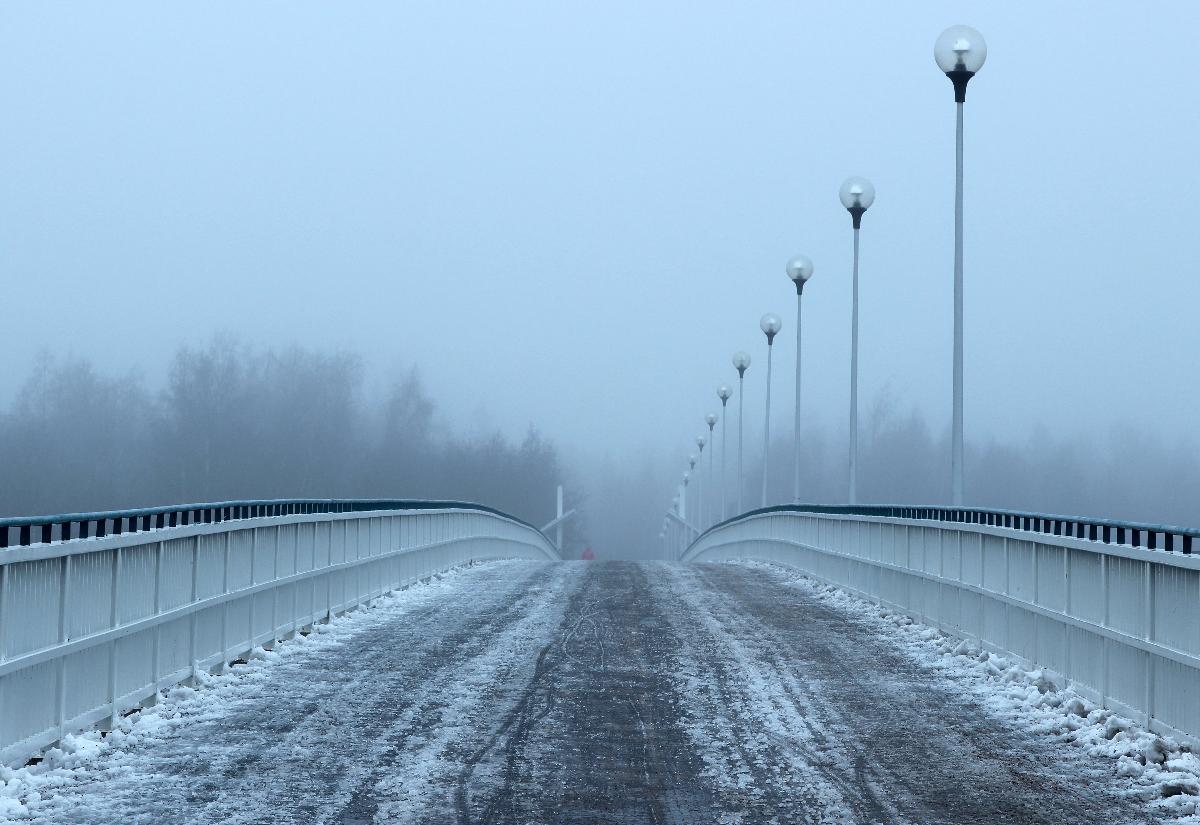 Pedestrian and bicycle bridge Korkeasaarensilta in fog in Oulu 