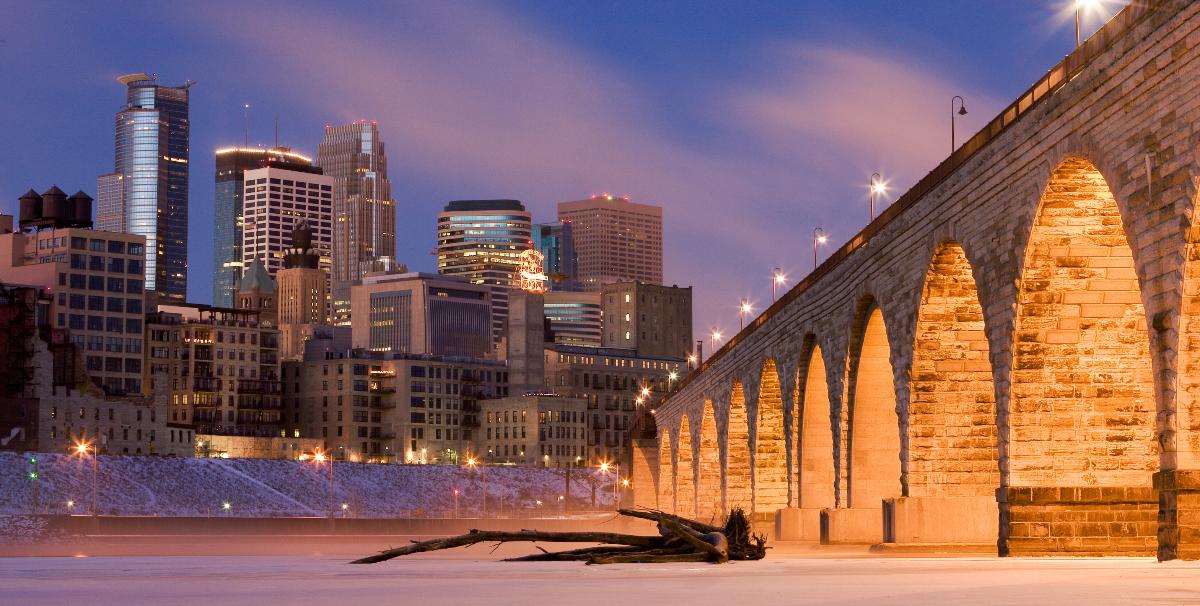 Downtown Minneapolis from across the Mississippi River One the right, the Stone Arch Bridge.