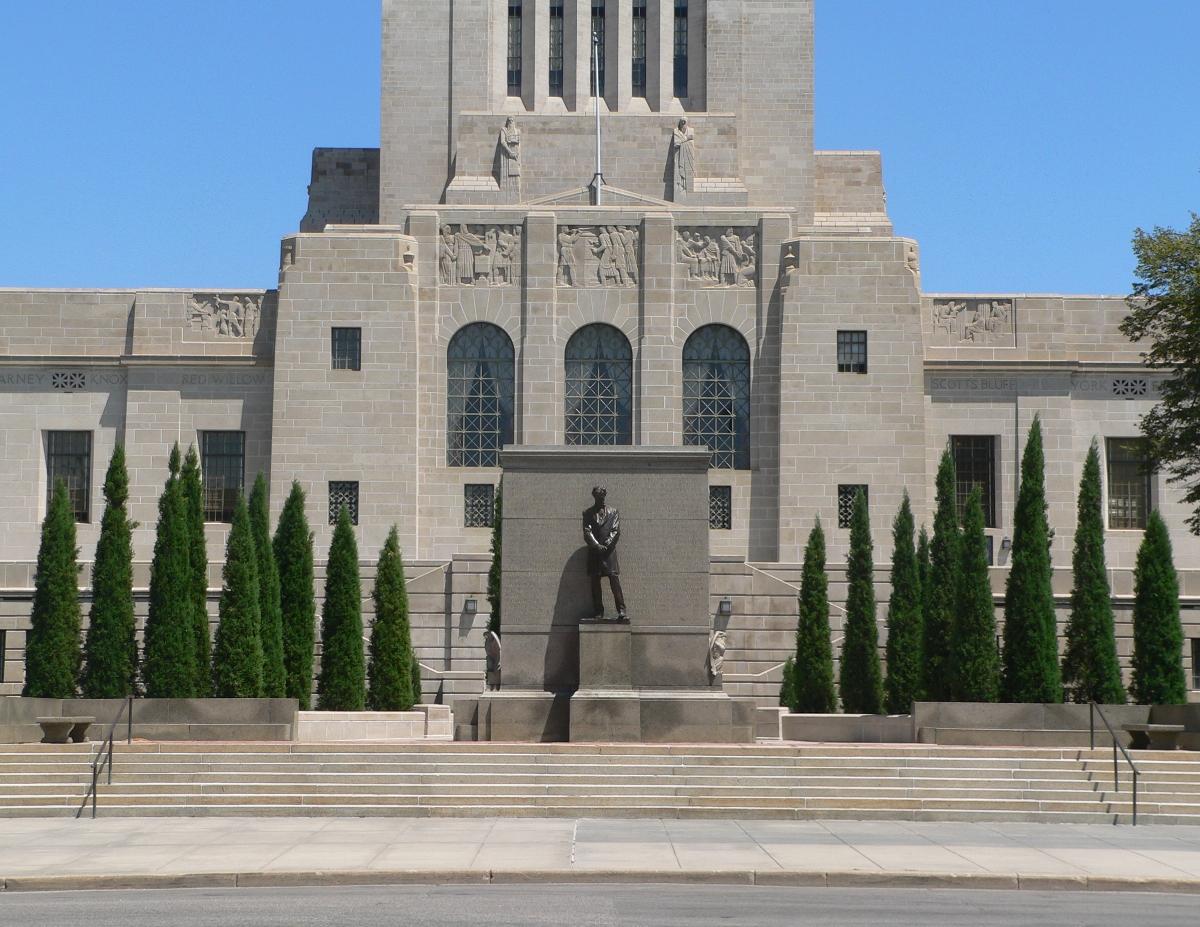 Nebraska State Capitol in Lincoln, Nebraska West entrance. In the foreground is a Daniel Chester French sculpture of Abraham Lincoln.