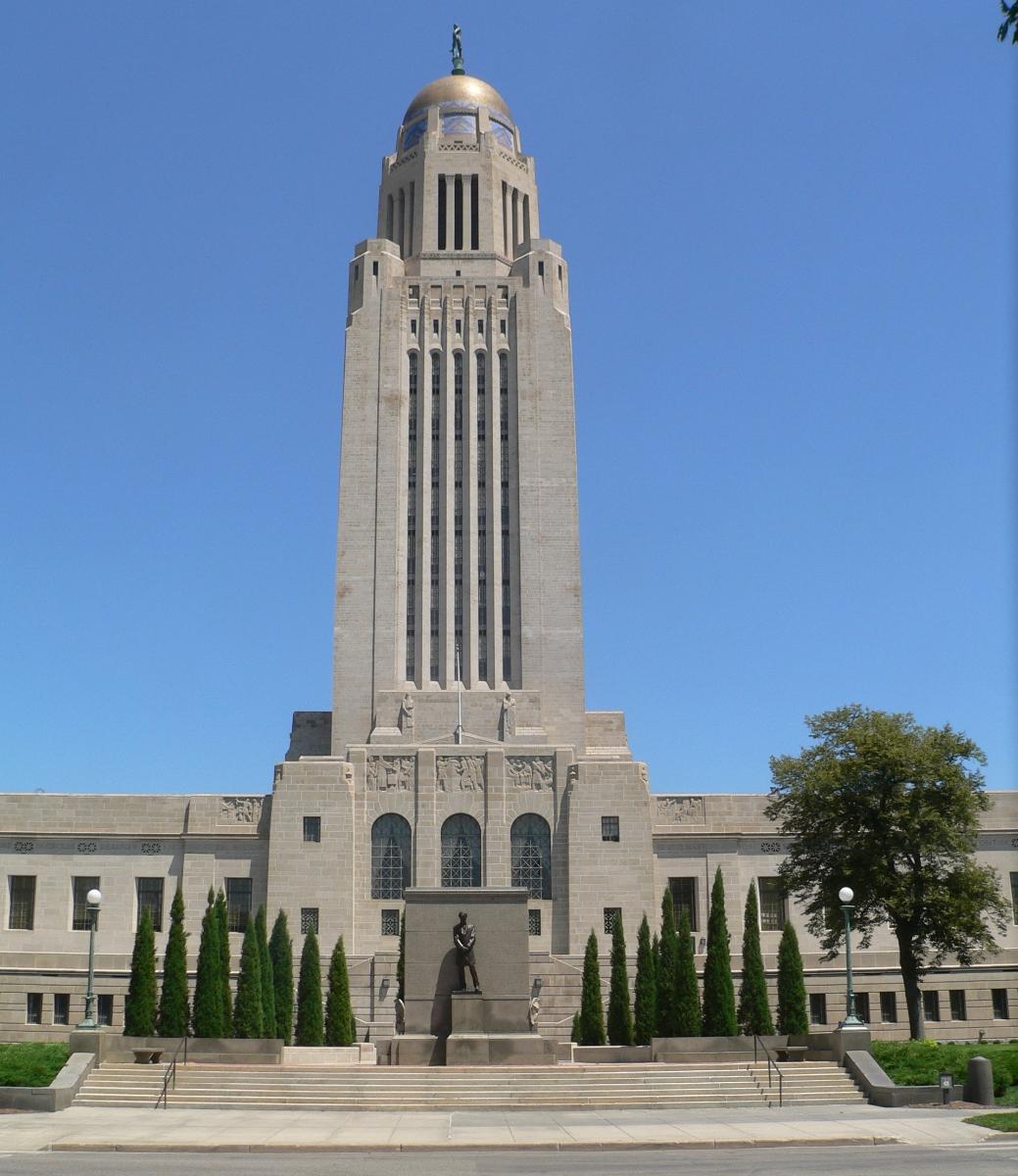 Nebraska State Capitol in Lincoln, Nebraska Seen from the west, looking east along Lincoln Mall from between 13th and 14th Streets. At the lower center of the photo is Daniel Chester French's sculpture of Abraham Lincoln.