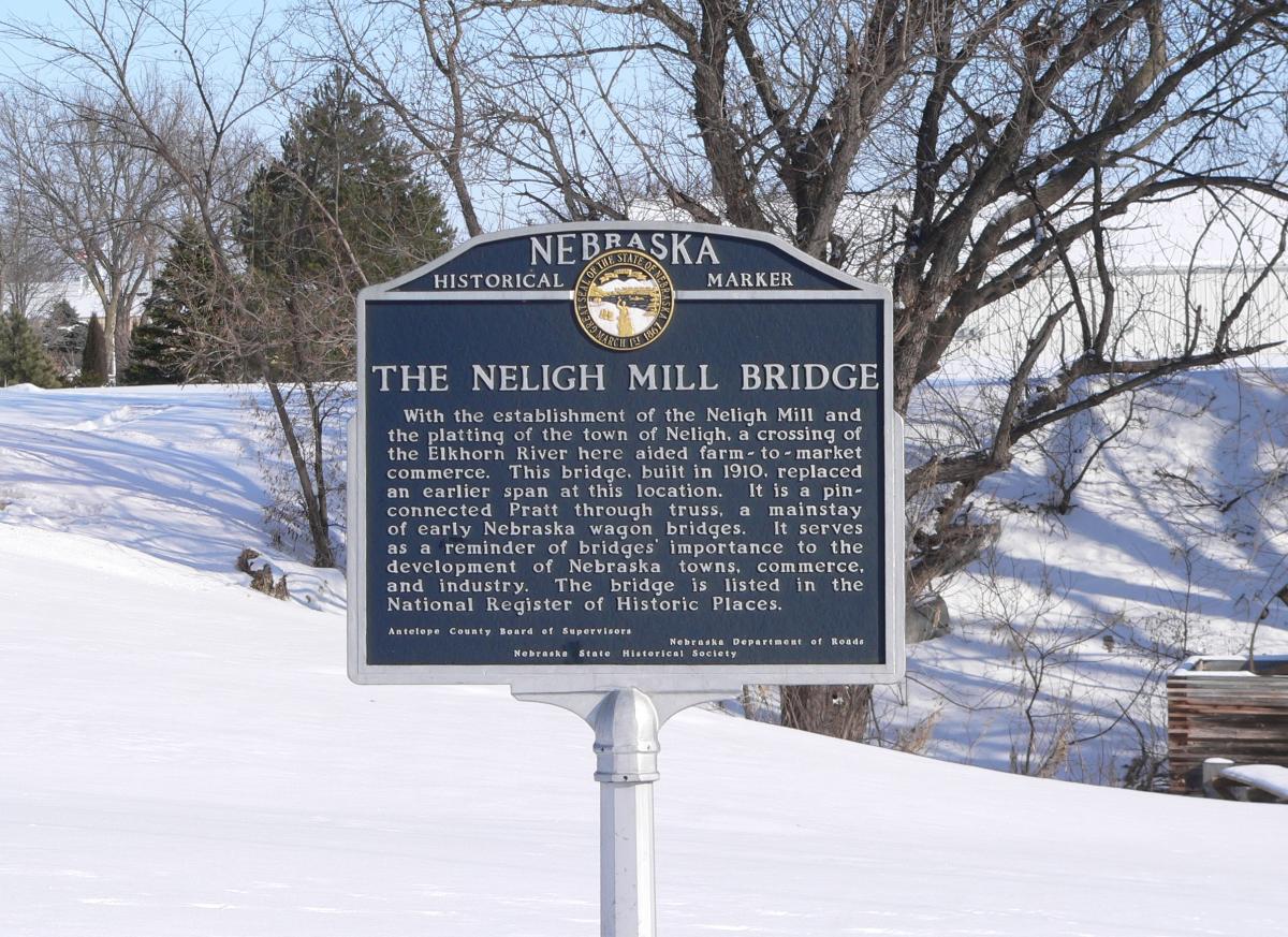 Neligh Mill Bridge Historical marker at Neligh Mill Bridge over the Elkhorn River in Neligh, Nebraska; seen from the southwest (upstream). The pin-connected Pratt through truss bridge was constructed in 1910; it is listed in the National Register of Historic Places.