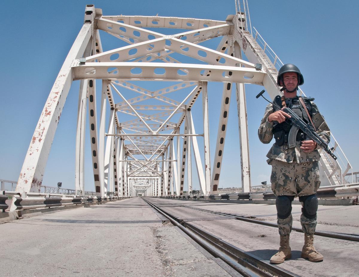 Afghanistan-Uzbekistan Friendship Bridge BALKH PROVINCE, Afghanistan (May 27, 2010) —An Afghan Border Policeman stands watch on the Freedom Bridge crossing the Amu Darya River. On 15th February, 1989 the last Soviet troops to withdraw from Afghanistan crossed the bridge into the, then, Uzbek Soviet Socialist Republic. The bridge now carries rail and vehicular traffic and is the only border crossing between Afghanistan and Uzbekistan. (U.S. Navy photo by Petty Officer 1st Class Mark O’Donald)