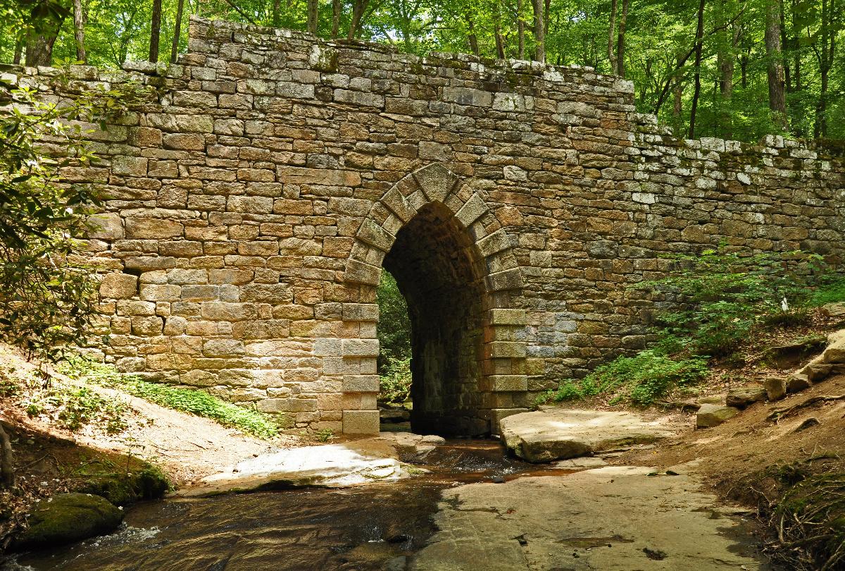 Poinsett Bridge Constructed in 1820, it is believed to be the oldest surviving bridge in the state. Named after Joel Poinsett, the 14 foot Gothic arch stone structure, stretches 130 feet over Little Gap Creek.