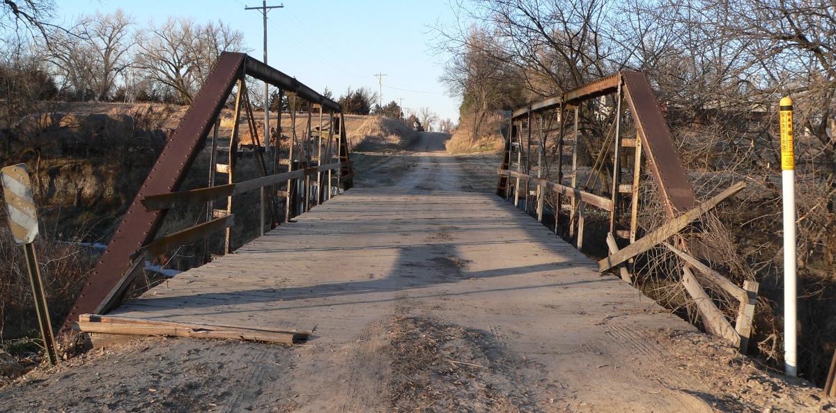 Sweetwater Mill Bridge in Buffalo County, Nebraska, seen from the south. The pin-jointed Pratt pony truss bridge carries Sweetwater Road across Mud Creek. It was built in 1909 by the Standard Bridge Company, and is listed in the National Register of Historic Places.
