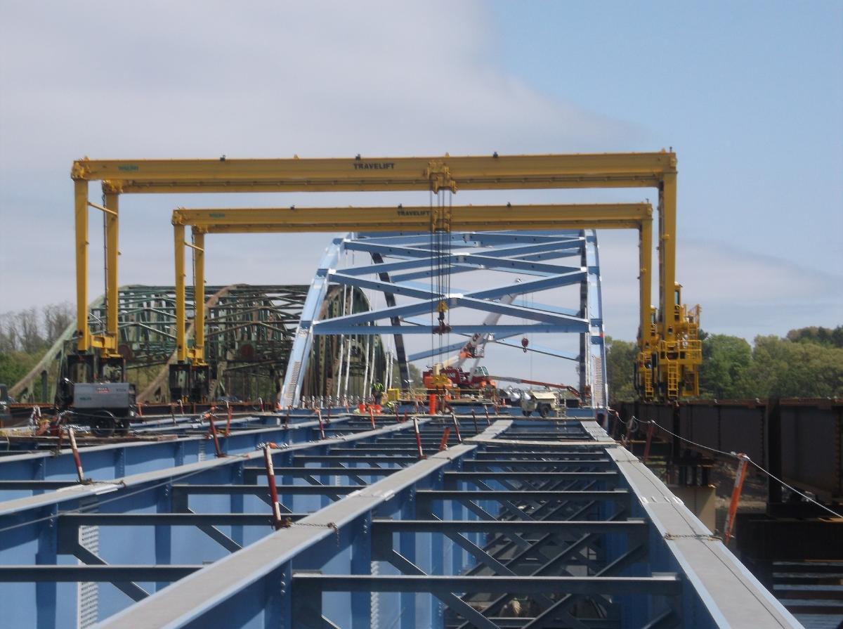 John Greenleaf Whittier Bridge Crews use the traveling gantry crane (yellow) to erect steel girders on the southern end of the new Whittier Bridge in Newburyport.