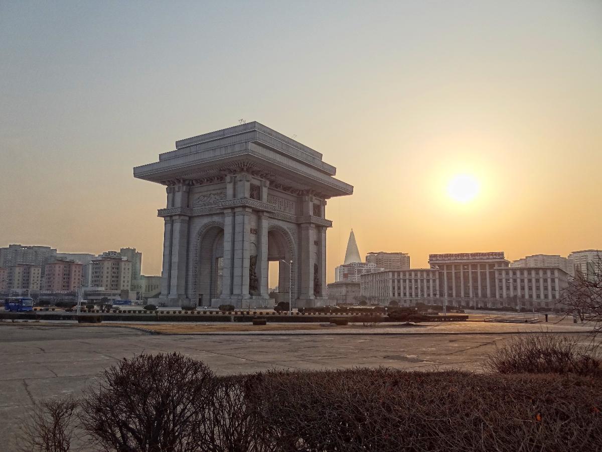 The Arch of Triumph in Pyongyang, photographed from the north-east in at sunset The pyramidal building in the background is the Ryugyong Hotel, the tallest building in the DPRK.