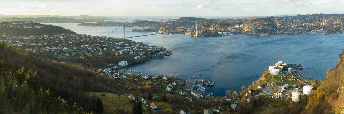 The neighbourhood of Kjøkkelvik in the city of Bergen (foreground), and the island of Askøy (background), in the county of Hordaland, Norway The two are connected by the Askøy Bridge, built 1989-1992.