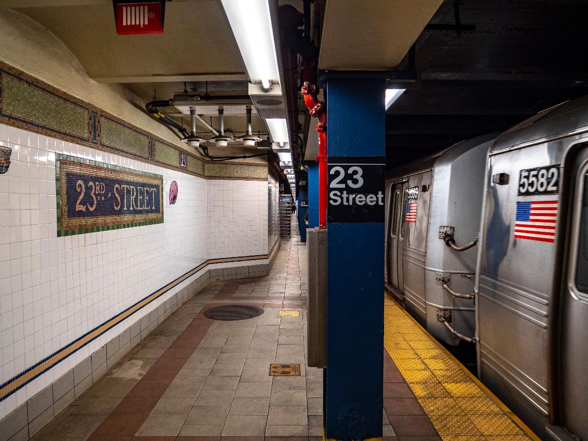 A view of the southbound platform of the BMT Broadway Line's 23rd Street station. An R46 W train is arriving. 