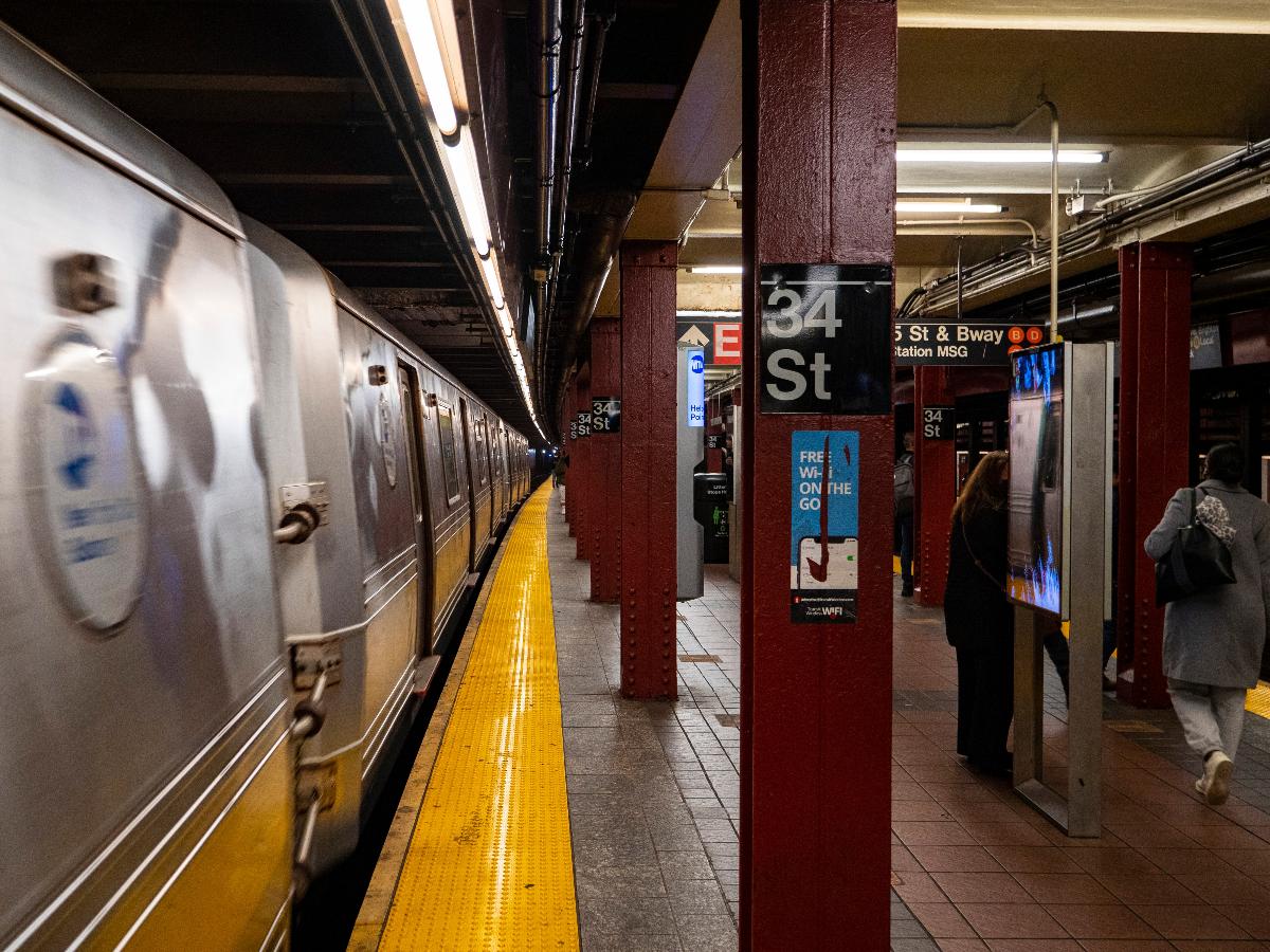 A view of the southbound platform of the BMT Broadway Line's 34th Street-Herald Square station. An R46 W train is departing. 
