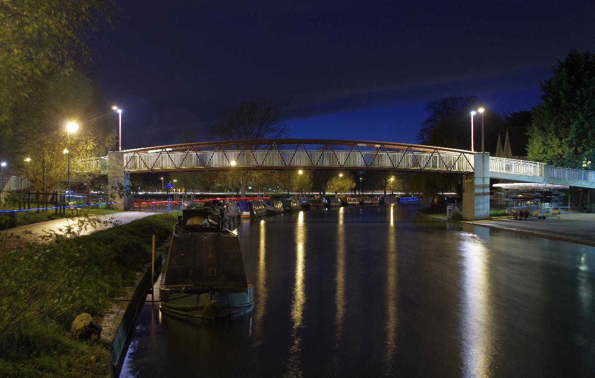 The River Cam in Cambridge at night This is the footbridge west of Elizabeth Way, with Midsummer Common on the left.