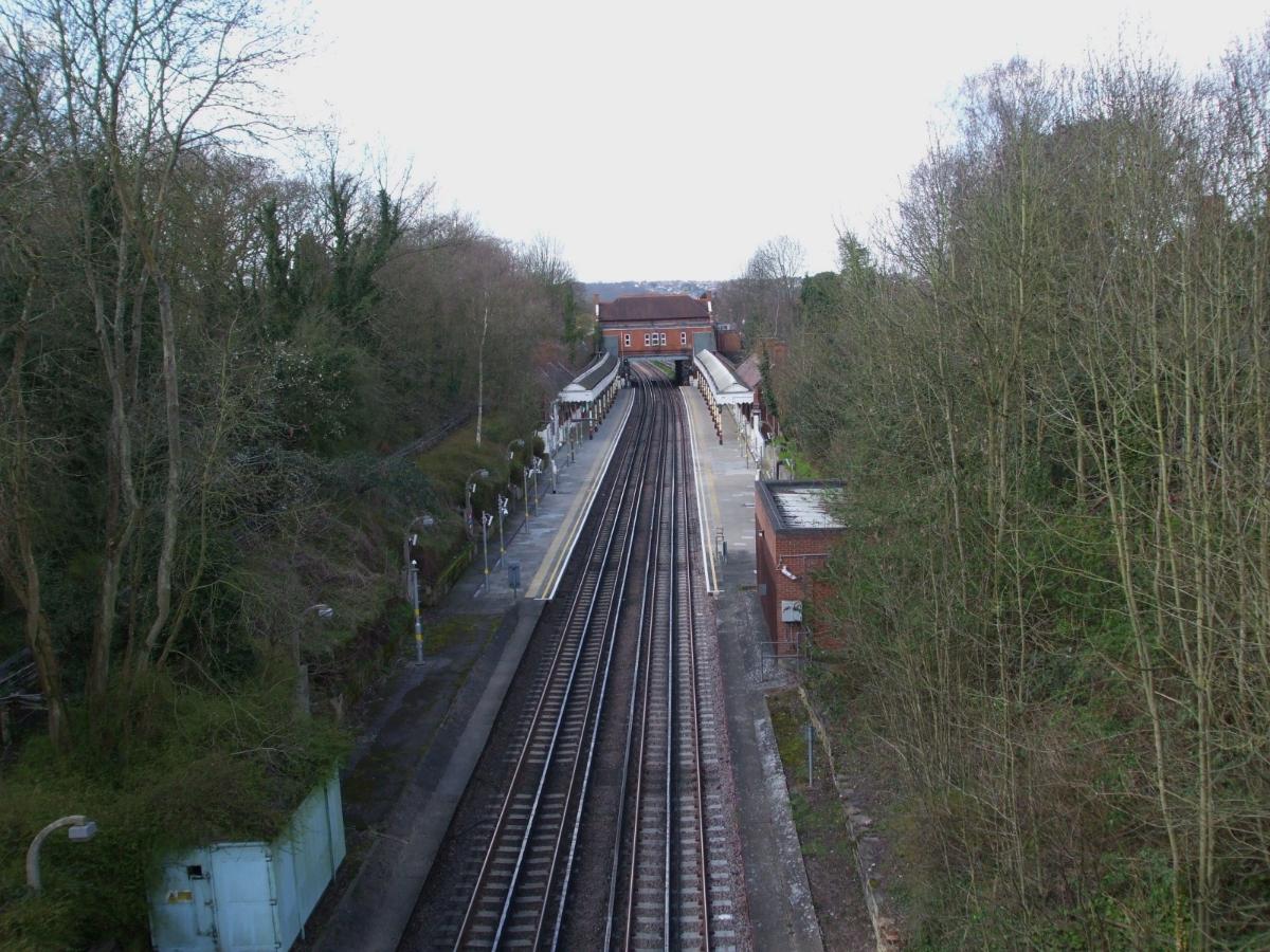Chigwell station looking west towards Woodford (though operationally "eastbound" because of the Hainault loop) from the A123 Hainault Road 