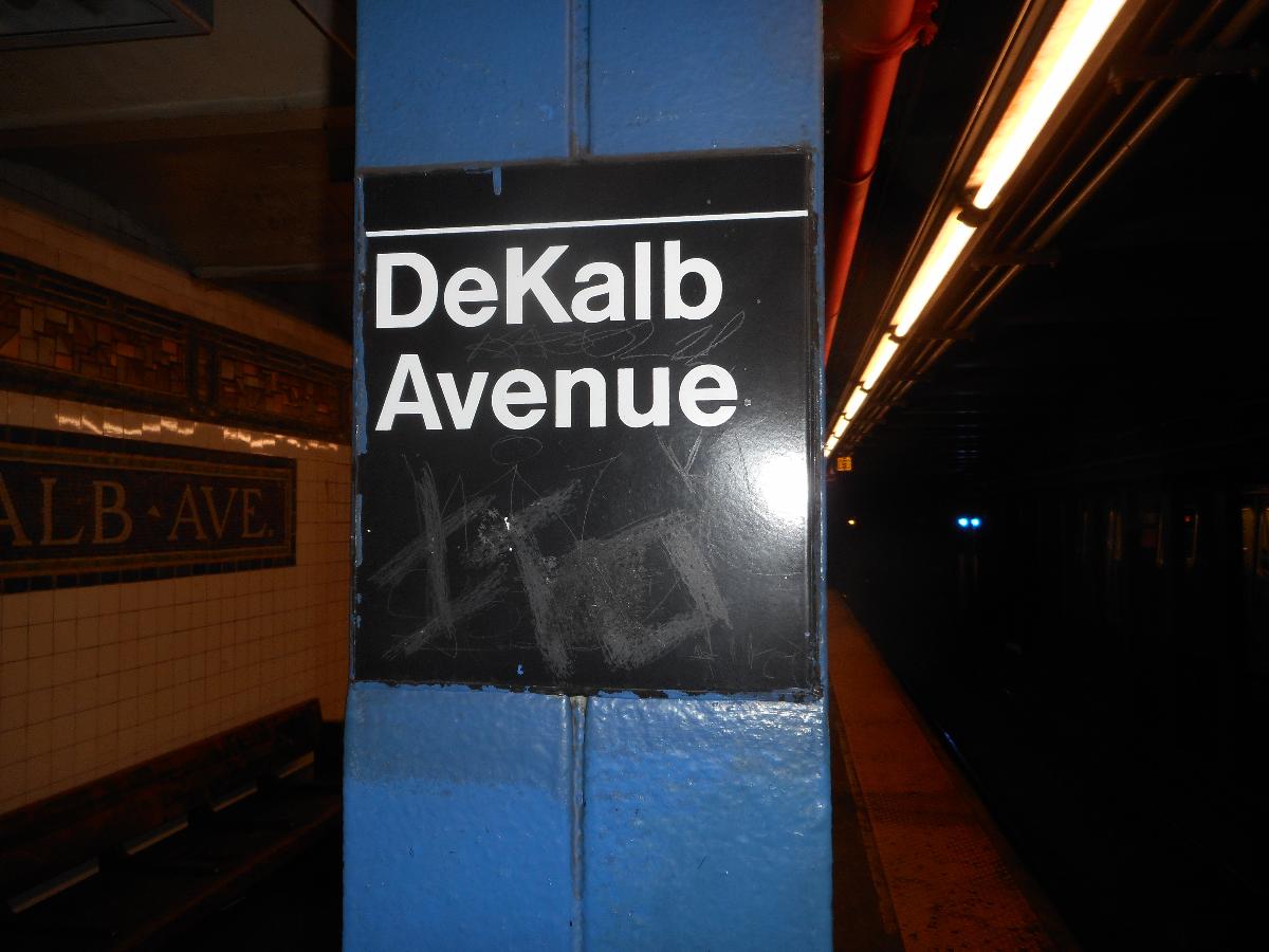 DeKalb Avenue Subway Station (Canarsie Line) Standard contemporary Helvetica sign on one of the pillars at the DeKalb Avenue (BMT Canarsie Line). The station also has plenty of pre-MTA mosaics from the BMT days, of course.