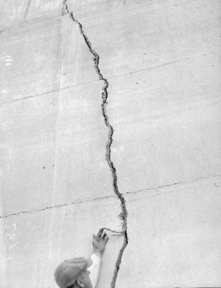 Media File No. 427243 Man pointing at crack in Saint Francis Dam after its collapse. Photo taken after the March 12, 1928 collapse of the Saint Francis Dam; this disastrous civil engineering failure cost over 600 lives in the resulting flood and brought the end of William Mulholland's career as the chief engineer of the Los Angeles Bureau of Water Works and Supply.