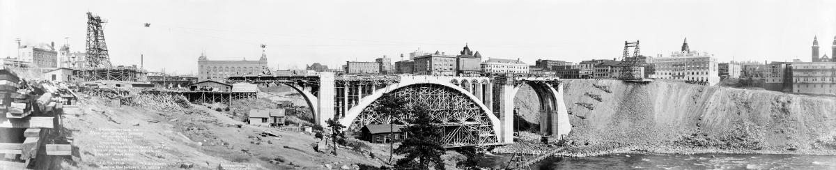 Construction of Monroe Street Bridge, Spokane, Washington Dimensions. Length of concrete work, 780 feet. Height of floor from water, 135 [feet]. Span of main arch, 281 [feet]. Engineers; J. C. Ralston, T. F. Kennedy, Morton MacCartney, J. F. Greene. Copyrighted A.D. 1911 by W. O. Reed, Spokane, Wash.