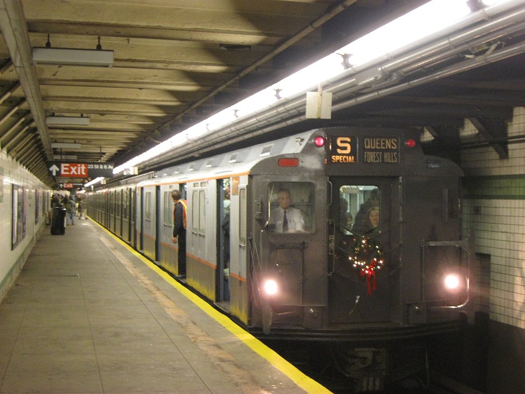 23rd Street station on 6 Avenue in New York City NYC Subway R7A car #1575 (wearing R10 colors and design) leads a special holiday V train, picking up customers