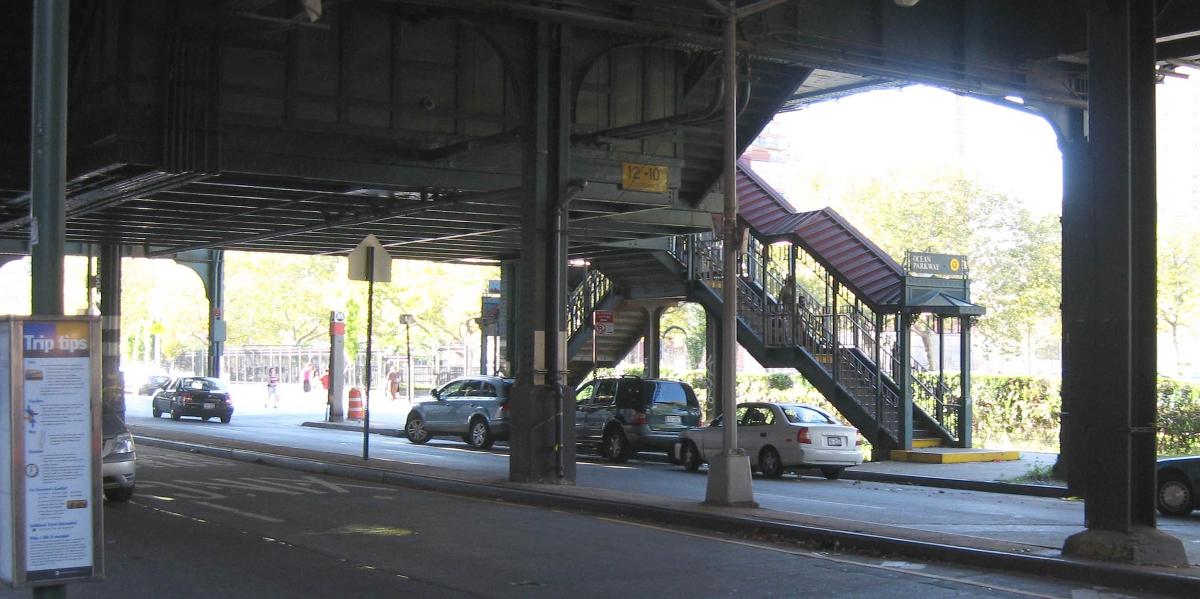 Looking north across Brighton Avenue, underneath the Brighton Line at en:Ocean Parkway (BMT Brighton Line) station stair on a sunny afternoon 