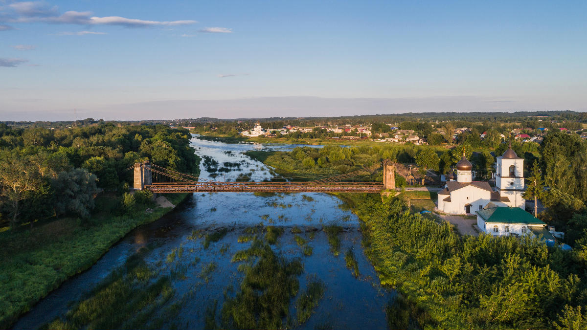 Aerial view – Northern Chain Bridge and Saint Nicholas Church in Ostrov, Pskov Oblast, Russia. 