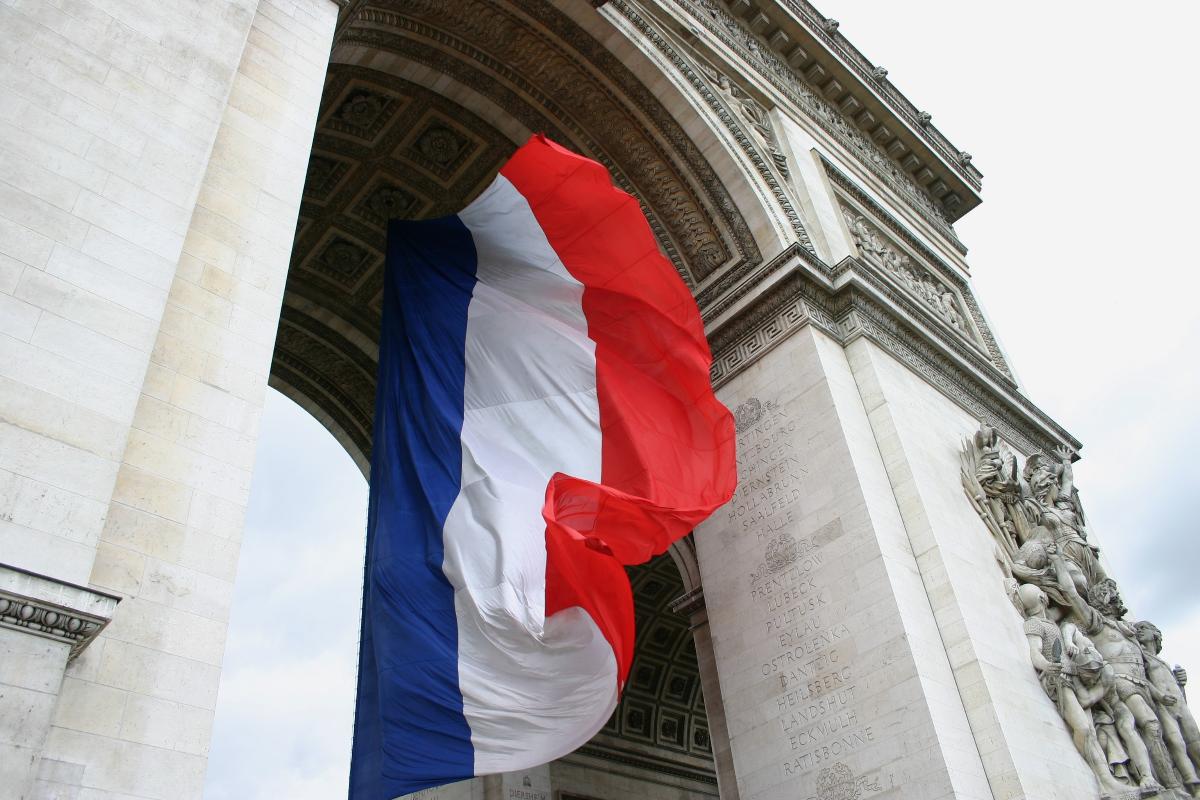 Arc de Triomphe with flag of France 
