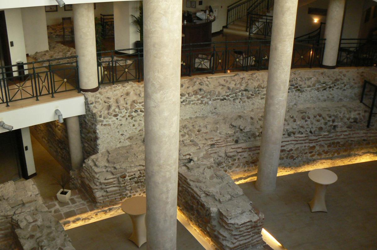 Remnants of the Serdica amphiteatre from the Roman times Discovered in the centre of Bulgarian capital Sofia in 2004-2006, during excavations works preceding the construction of a private hotel. The construction works were not timely stopped and currently a part of these remnants can be seen in the basement of the hotel. Public access is granted from 10 to 16 o'clock every day except Monday.