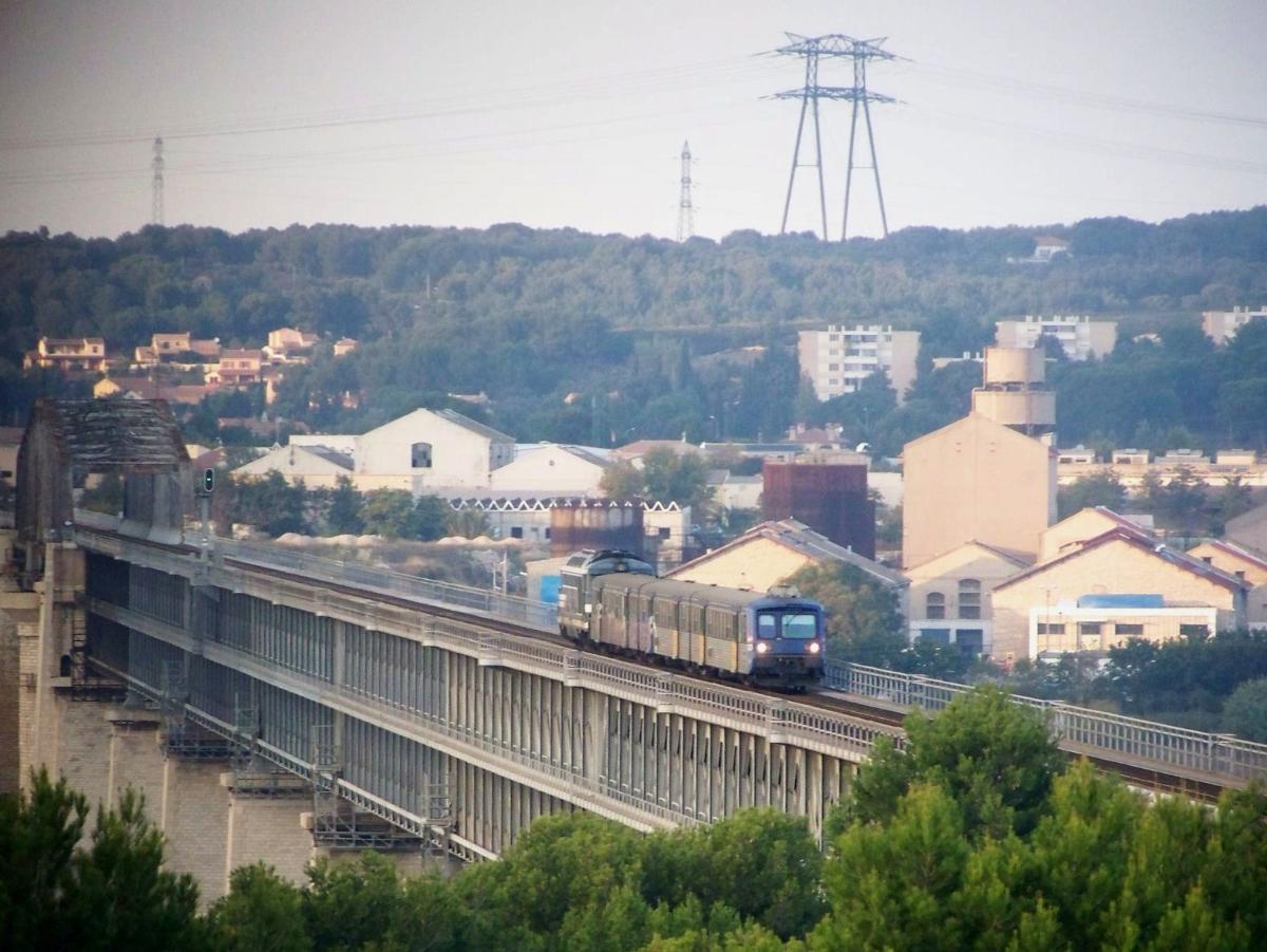 Caronte Bridge French regional train coming from Miramas and moving to Marseille crosses the viaduc of Caronte bridge just before entering the station of Martigues in Bouches-du-Rhône.